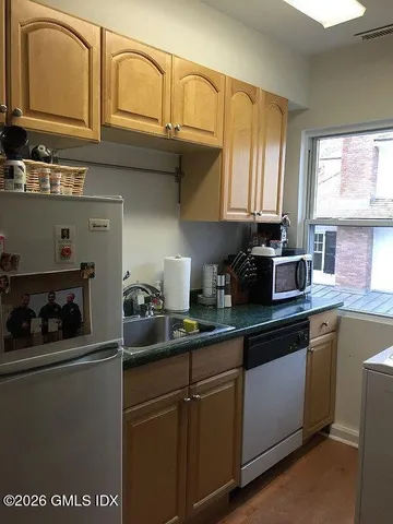 a white stove top oven sitting inside of a kitchen