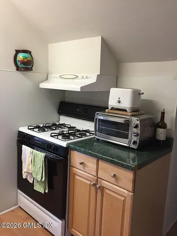 a bedroom with a bed and a night stand