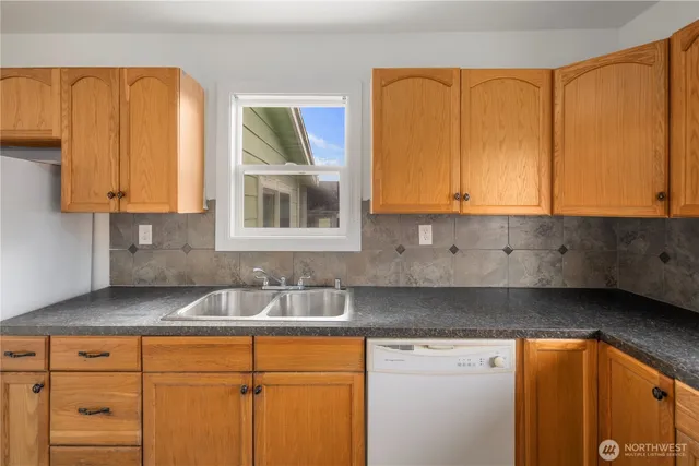 a kitchen with granite countertop a sink and a window