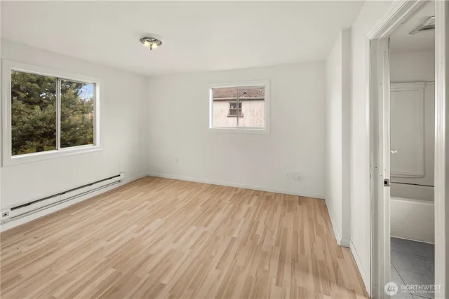 wooden floor in an empty room with a window