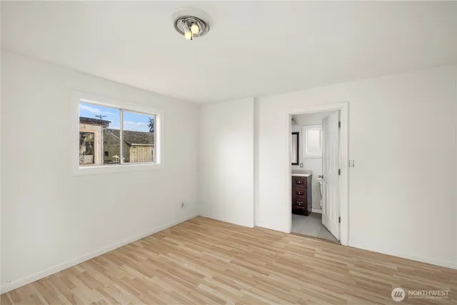 an empty room with a bathroom and a sink