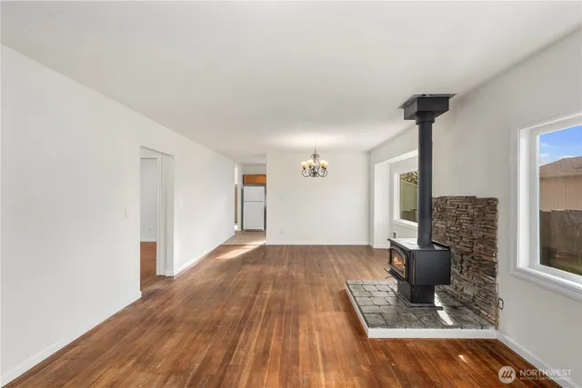 a view of a livingroom with wooden floor and a ceiling fan