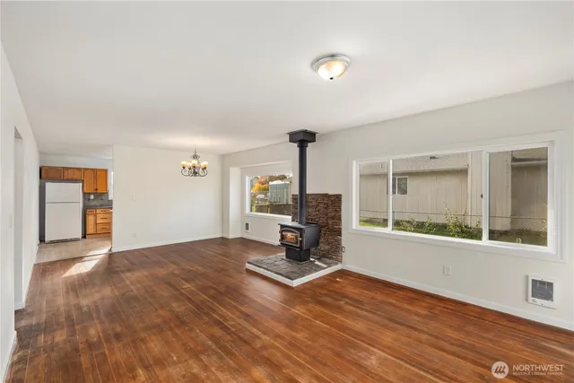 a view of a room with wooden floor and a window