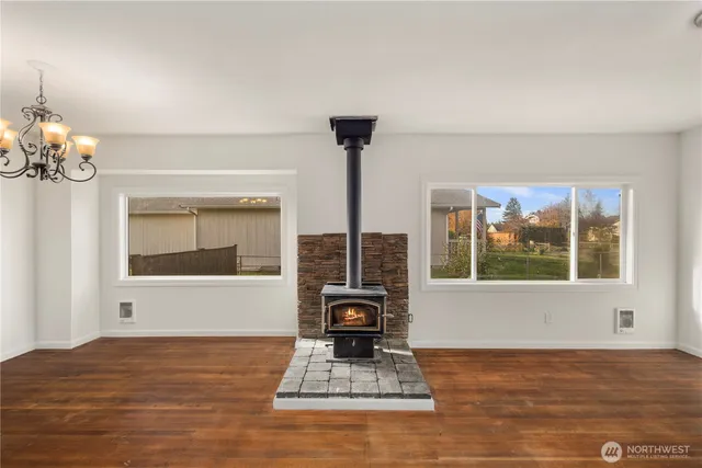 a living room with furniture and a floor to ceiling window