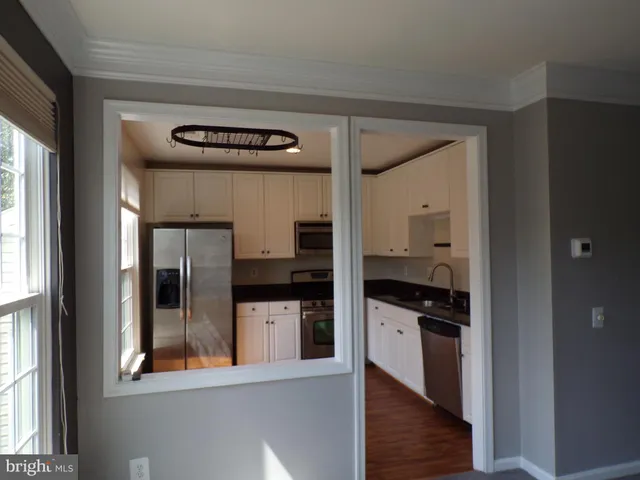 a kitchen with stainless steel appliances granite countertop a refrigerator and a stove