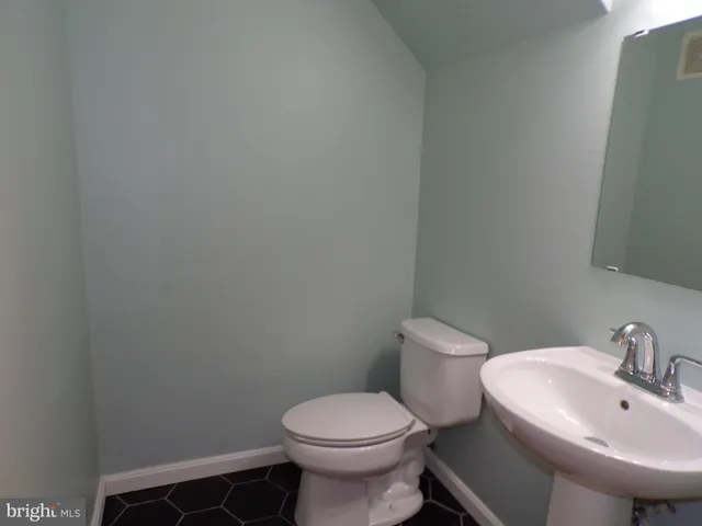 a white toilet sitting next to a white sink
