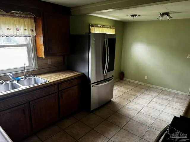 a view of a room with wooden floor and window