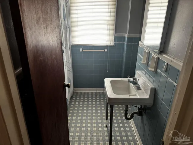 an empty room with wooden floor and closet