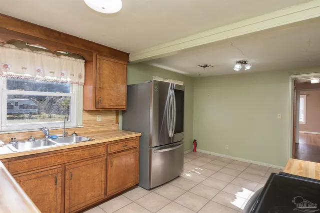 a kitchen with stainless steel appliances granite countertop a refrigerator and a sink