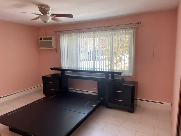 a room with a dresser and a window