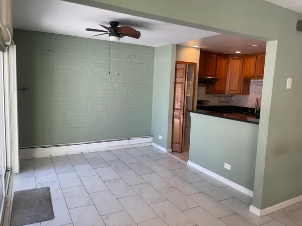 a view of a kitchen with a sink and a refrigerator