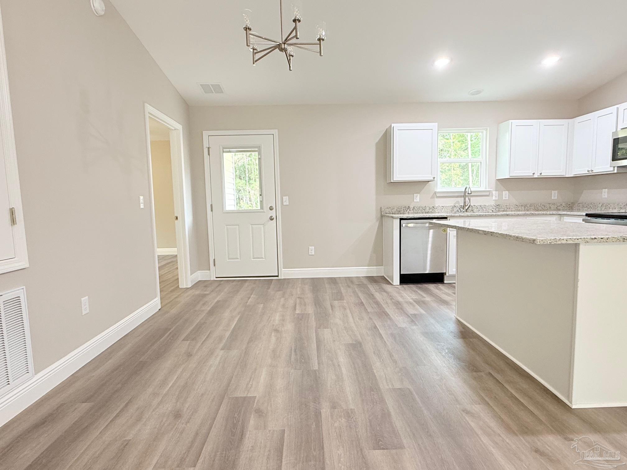 7236 Par Lane Milton, FL 32570 - Photo 3 of 10 a view of a kitchen with a sink and dishwasher with wooden floor