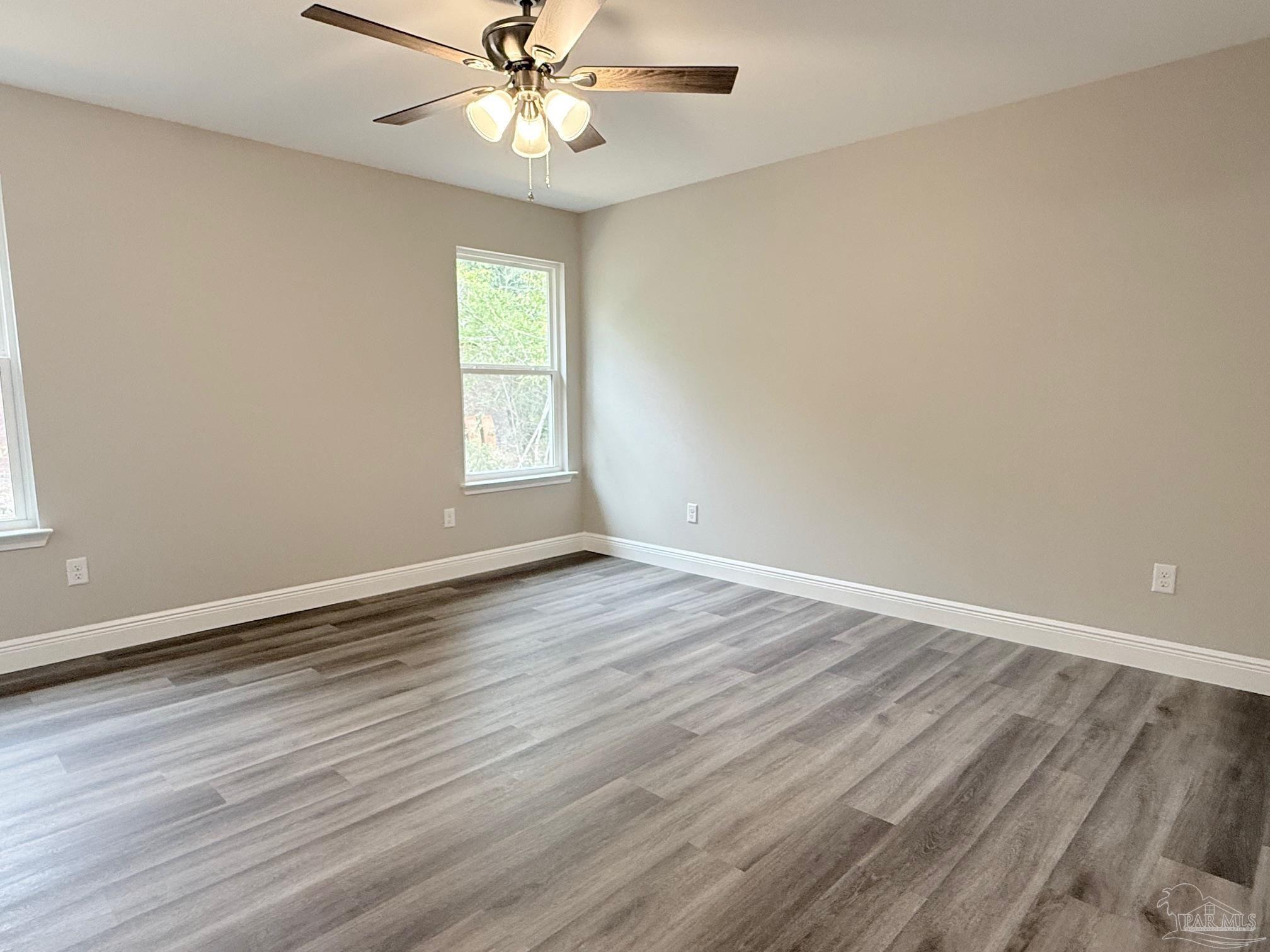7236 Par Lane Milton, FL 32570 - Photo 5 of 10 a view of an empty room with wooden floor and a window