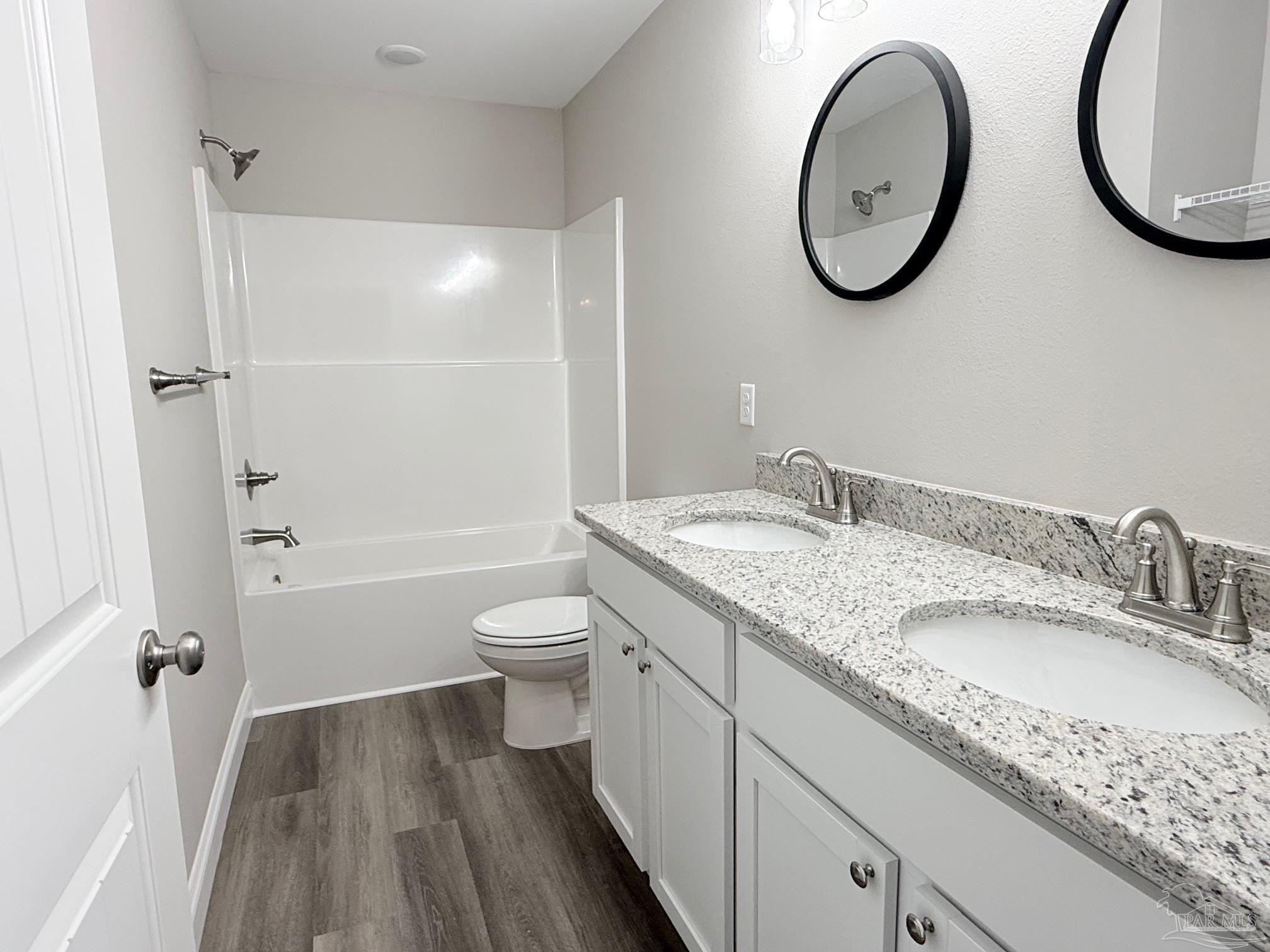 7236 Par Lane Milton, FL 32570 - Photo 6 of 10 a bathroom with a granite countertop sink toilet and a mirror