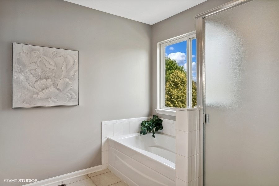3090 Whitney Road Aurora, IL 60502 - Photo 14 of 24 a bath tub sitting in a bathroom next to a window