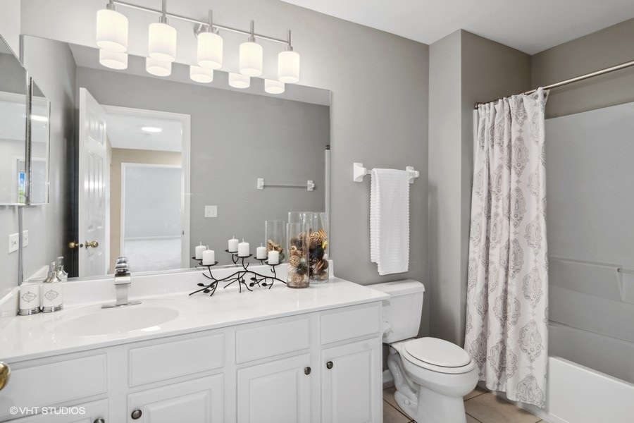3090 Whitney Road Aurora, IL 60502 - Photo 18 of 24 a bathroom with a double vanity sink mirror and toilet