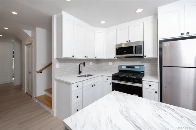 a kitchen with a refrigerator stove and microwave