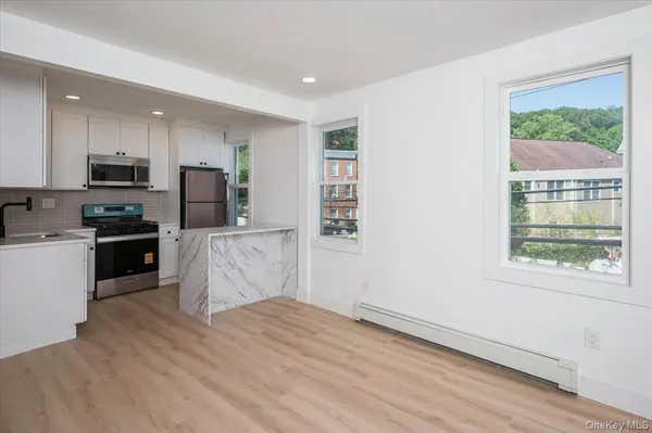 a kitchen with wooden floors and refrigerator