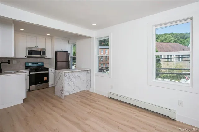 a kitchen with wooden floors and refrigerator