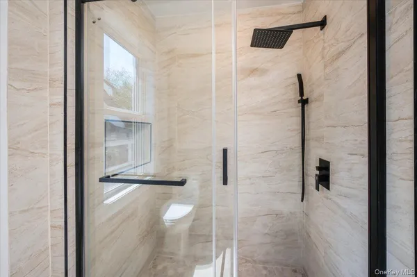 a bathroom with a glass shower door