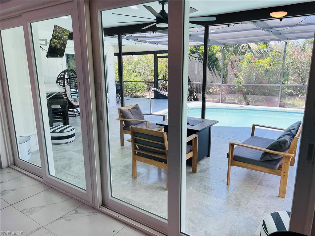 4439 Parrot Avenue Naples, FL 34104 - Photo 13 of 14 Entryway featuring a sunroom and a ceiling fan