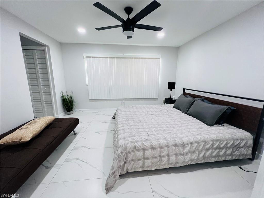 4439 Parrot Avenue Naples, FL 34104 - Photo 6 of 14 Bedroom with marble look tile flooring, ceiling fan, and a closet