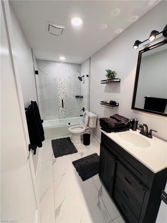 4439 Parrot Avenue Naples, FL 34104 - Photo 8 of 14 Bathroom featuring vanity, light marble finish floors, combined bath / shower with glass door, and recessed lighting