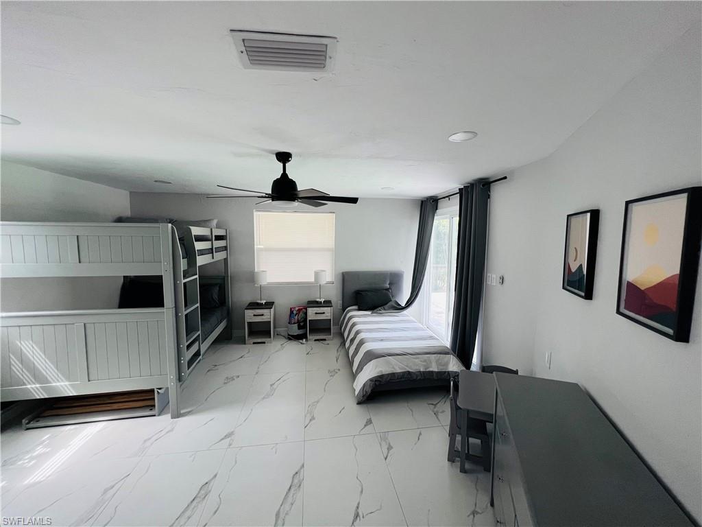 4439 Parrot Avenue Naples, FL 34104 - Photo 10 of 14 Bedroom featuring light marble finish floors and ceiling fan