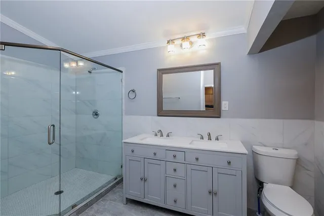 a bathroom with a granite countertop sink mirror and toilet
