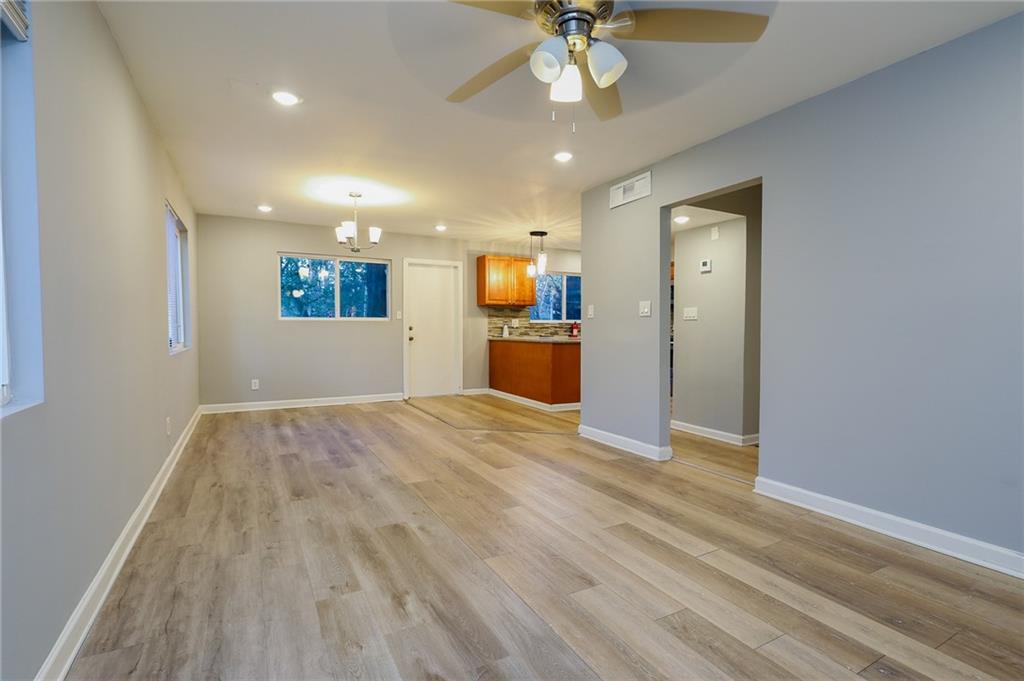 1277 Goodwin Road Northeast, Unit 1277 Atlanta, GA 30324 - Photo 2 of 15 a view of empty room with wooden floor and ceiling fan