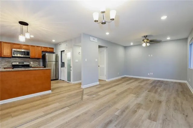 a view of a kitchen with a sink and a refrigerator
