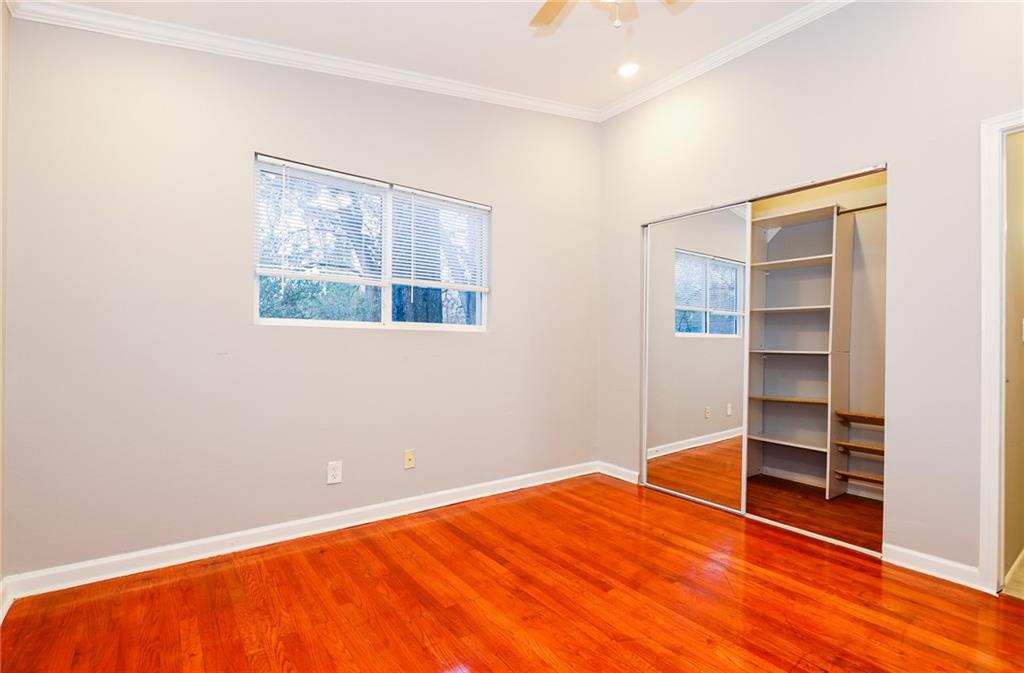 1277 Goodwin Road Northeast, Unit 1277 Atlanta, GA 30324 - Photo 8 of 15 a view of empty room with wooden floor and cabinet