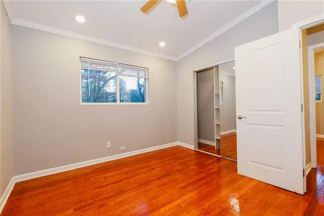 a view of empty room with wooden floor