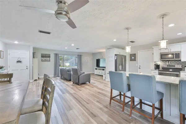 a large kitchen with a table and chairs