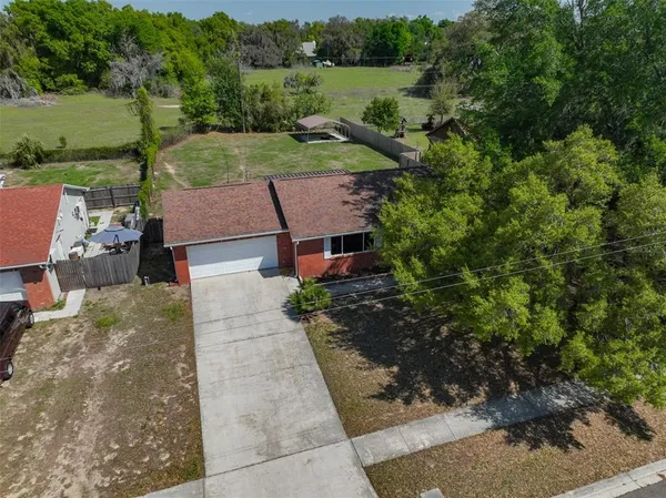 an aerial view of a house with garden space and street view