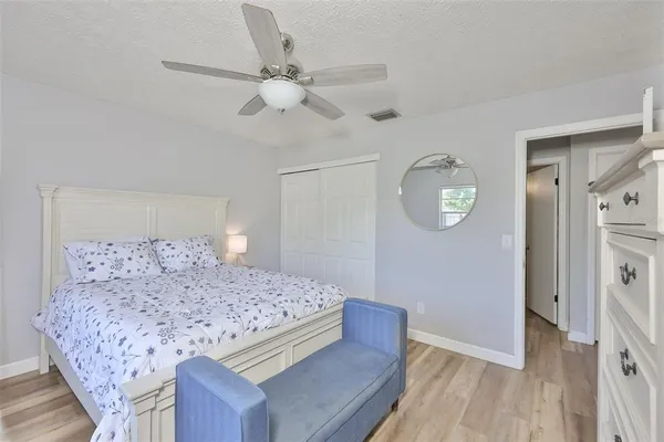 a bedroom with a large bed and a chandelier