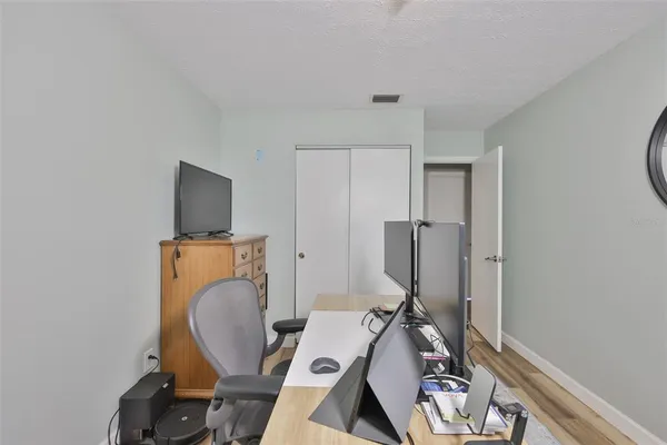 a view of workspace with wooden floor windows