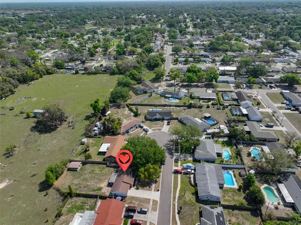 an aerial view of residential houses with outdoor space