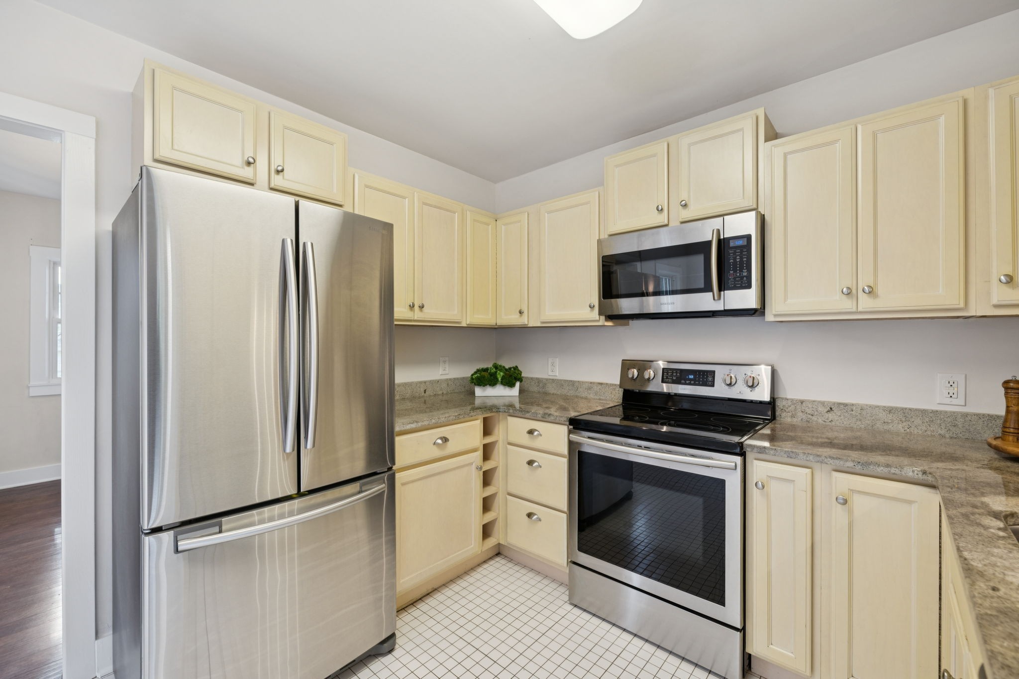 405 Lawrence Street Old Hickory, TN 37138 - Photo 17 of 52 a kitchen with stainless steel appliances white cabinets white stove a microwave and a refrigerator
