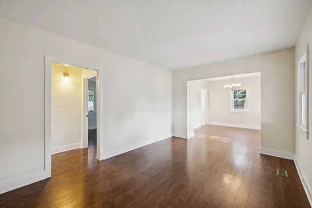 a bathroom with a double vanity sink and mirror with toilet