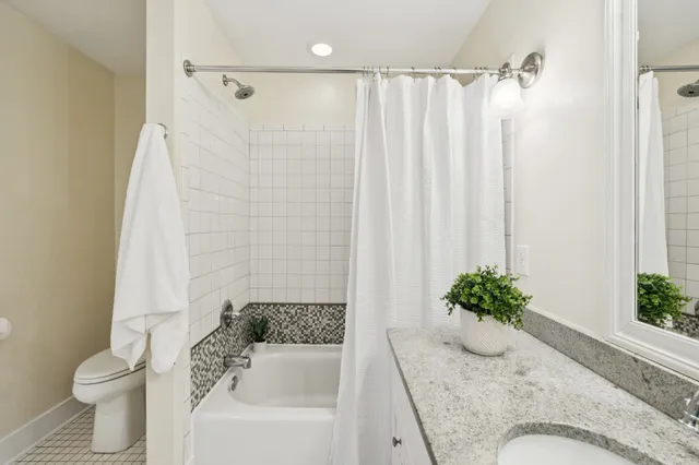 a bathroom with a sink a mirror and a shower