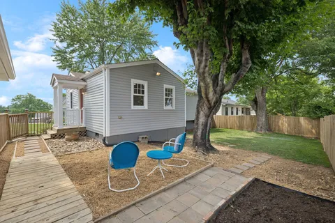 a view of a backyard with a large tree