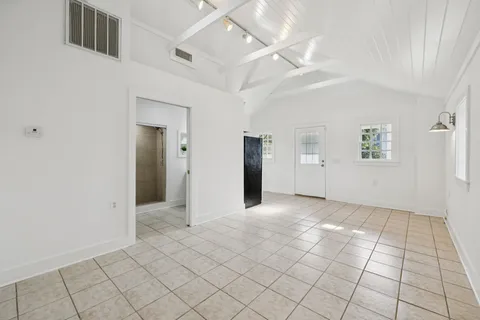 a white refrigerator freezer and a stove sitting inside of a kitchen with cabinets