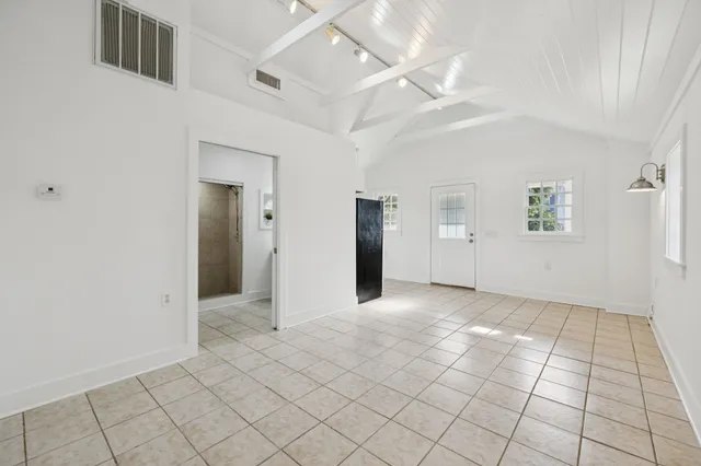 a white refrigerator freezer and a stove sitting inside of a kitchen with cabinets