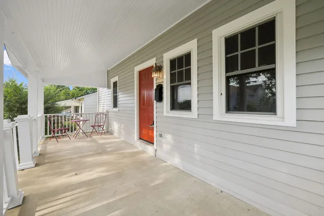 a view of house with backyard outdoor seating and windows