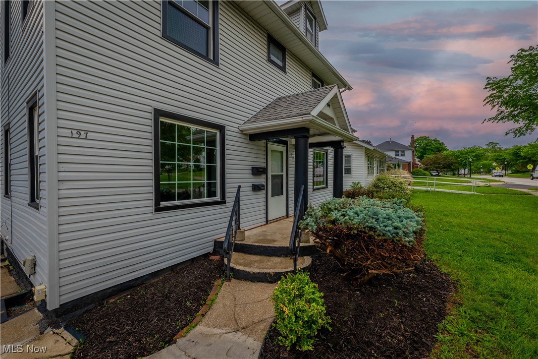 197 East Wilbeth Road Akron, OH 44301 - Photo 3 of 22 Exterior entry at dusk with a yard