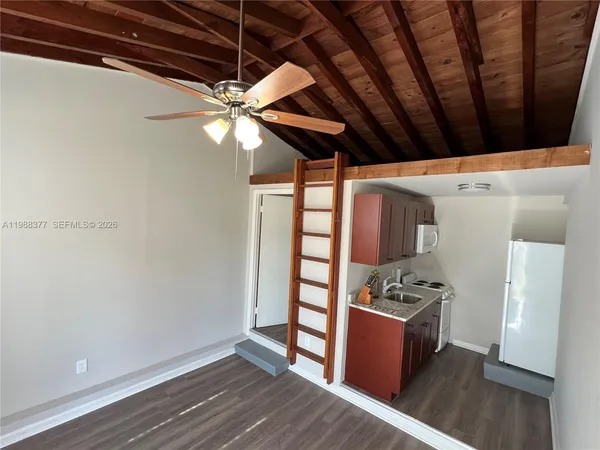 a view of kitchen with stainless steel appliances cabinets and wooden floor