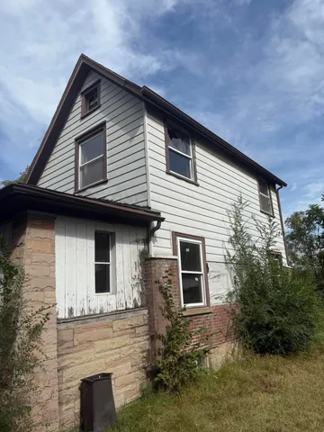a front view of a house with plants