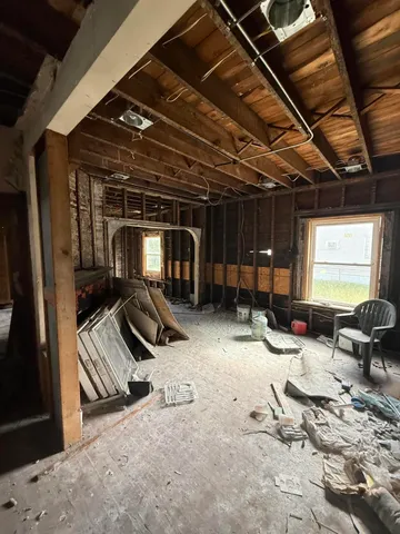 a bathroom with a granite countertop sink and a window