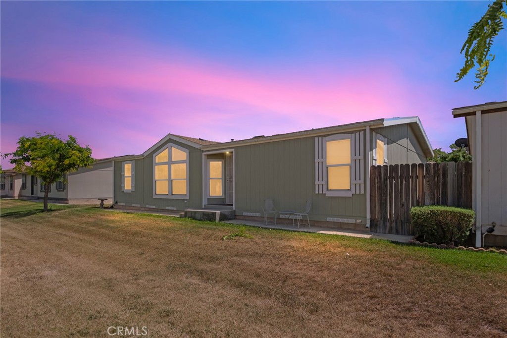21621 Sandia Road, Unit 128 Apple Valley, CA 92308 - Photo 1 of 41 a front view of a house with a yard and garage